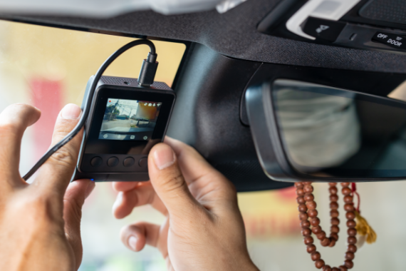 hand-technician-installing-front-camera-car-recorder-windscreen-car-570x380